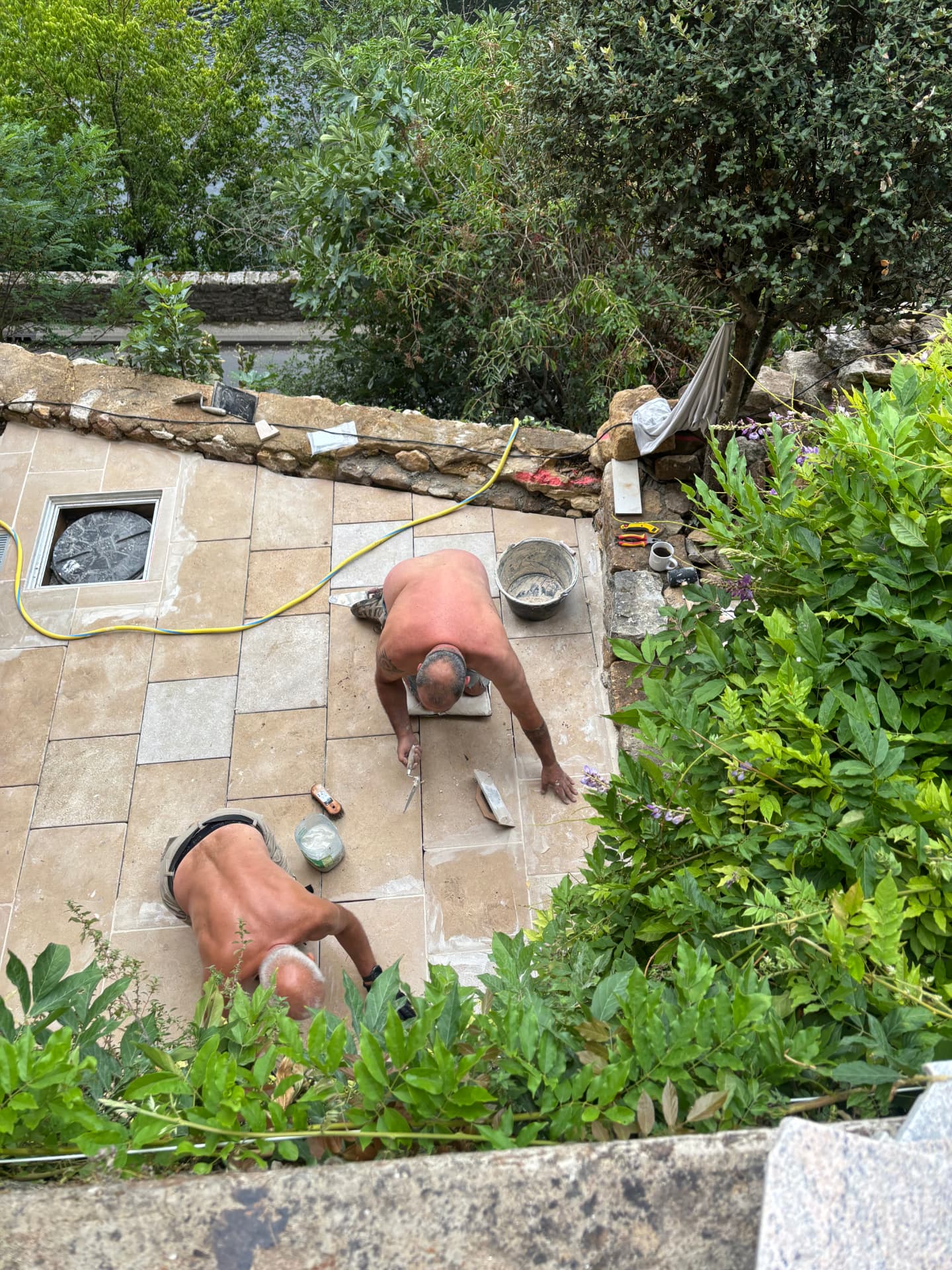 Jose and Pete laying the natural stone tiles