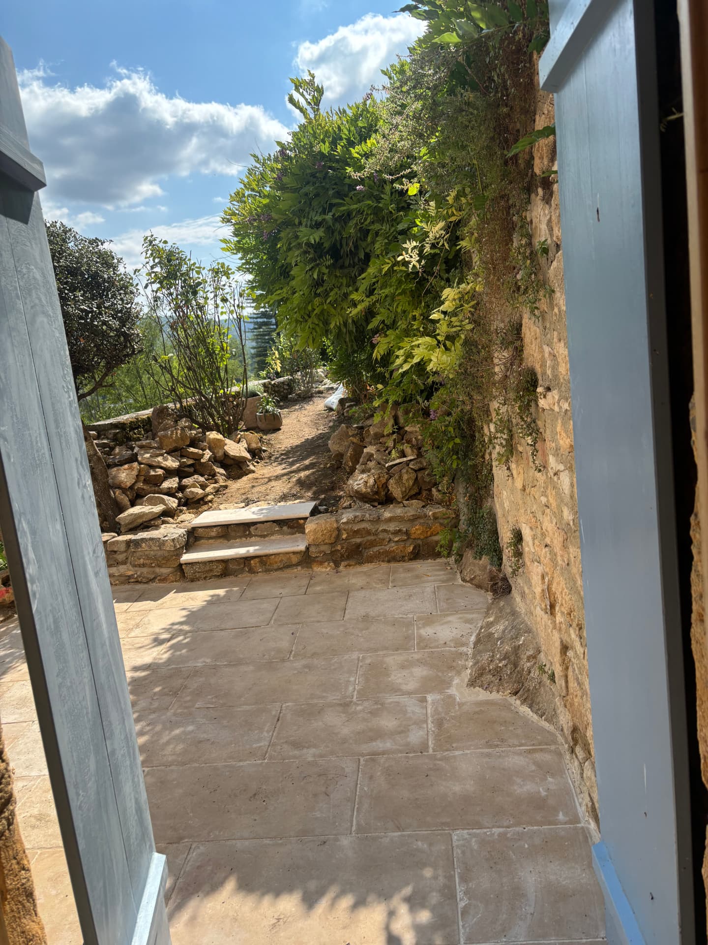 View from the doorway across the stone patio to the stone steps