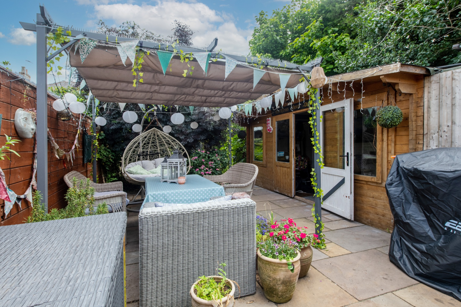 View of the finished courtyard toward the summerhouse with canopy and bunting