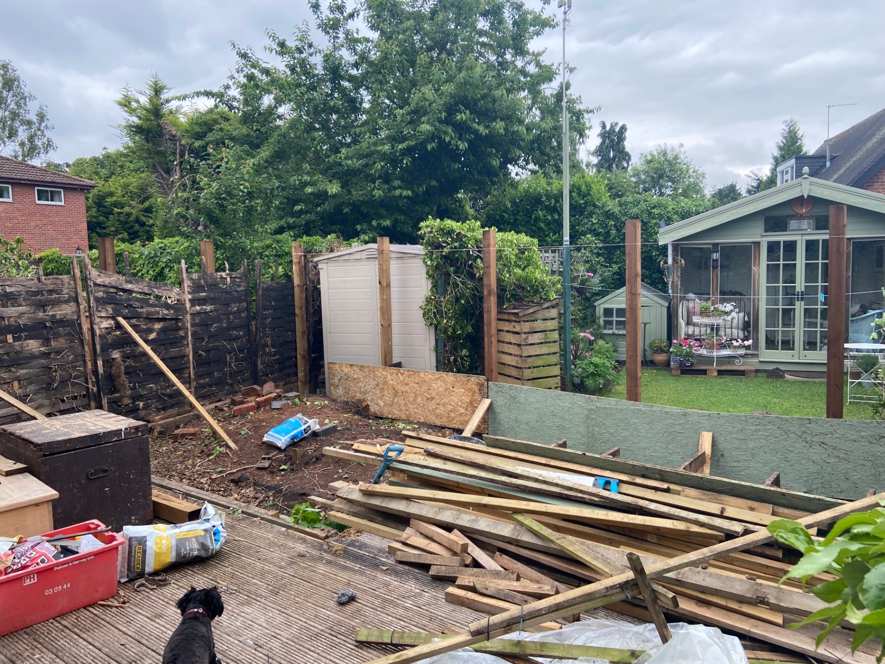 Old decking lifted and fence posts prepared during the build