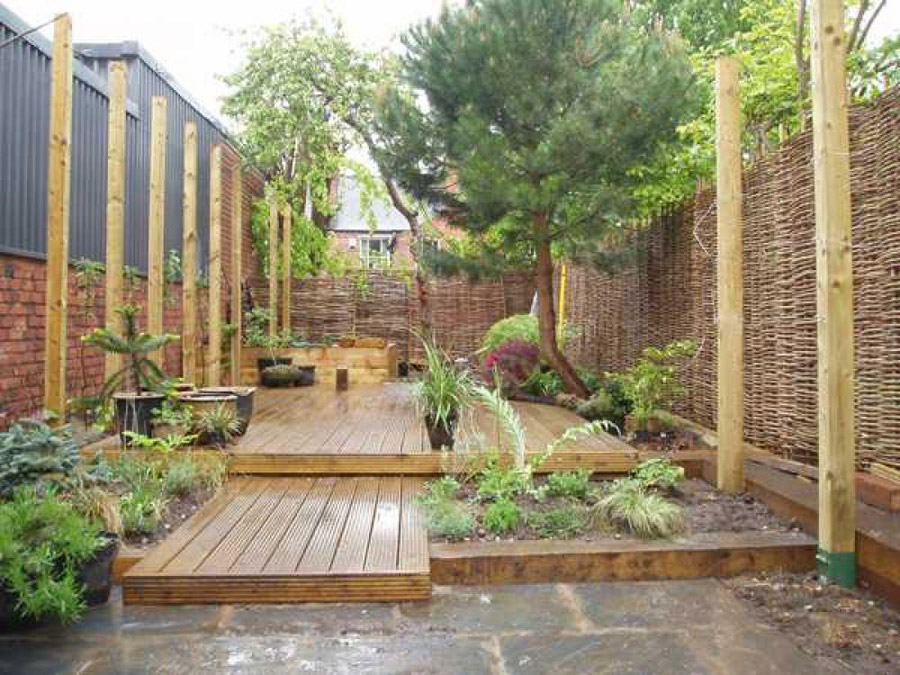 Tiered timber decking, willow screening and mixed planting in a Midlands garden built by Sil Landscapes